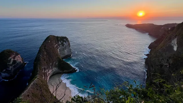 Kelingking cliff and beach at sunset.