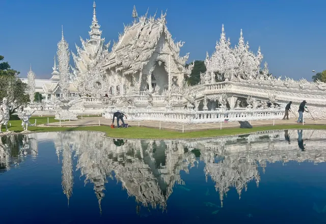 The White Temple reflected in a pond.